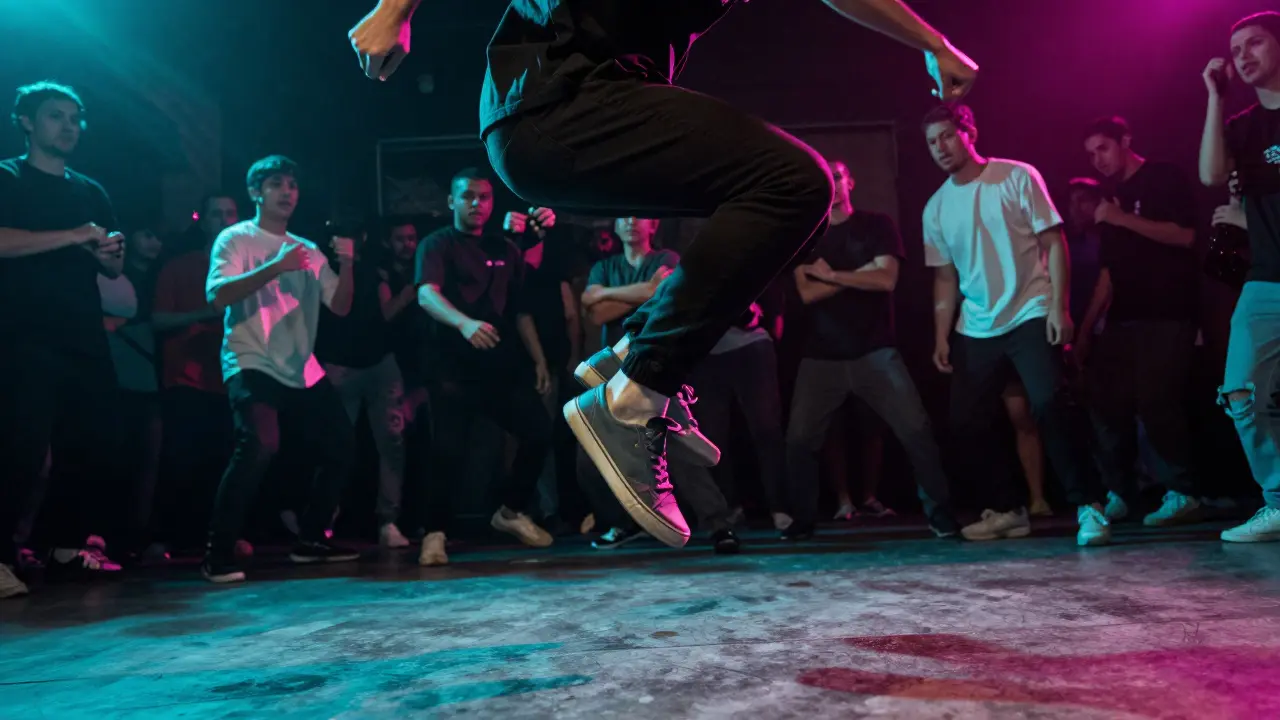 Person jumping to beat wearing sneakers at rave